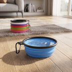Collapsible dog bowl filled with water on a wooden floor