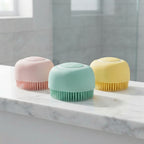 Dog shampoo brushes on a bathroom surface