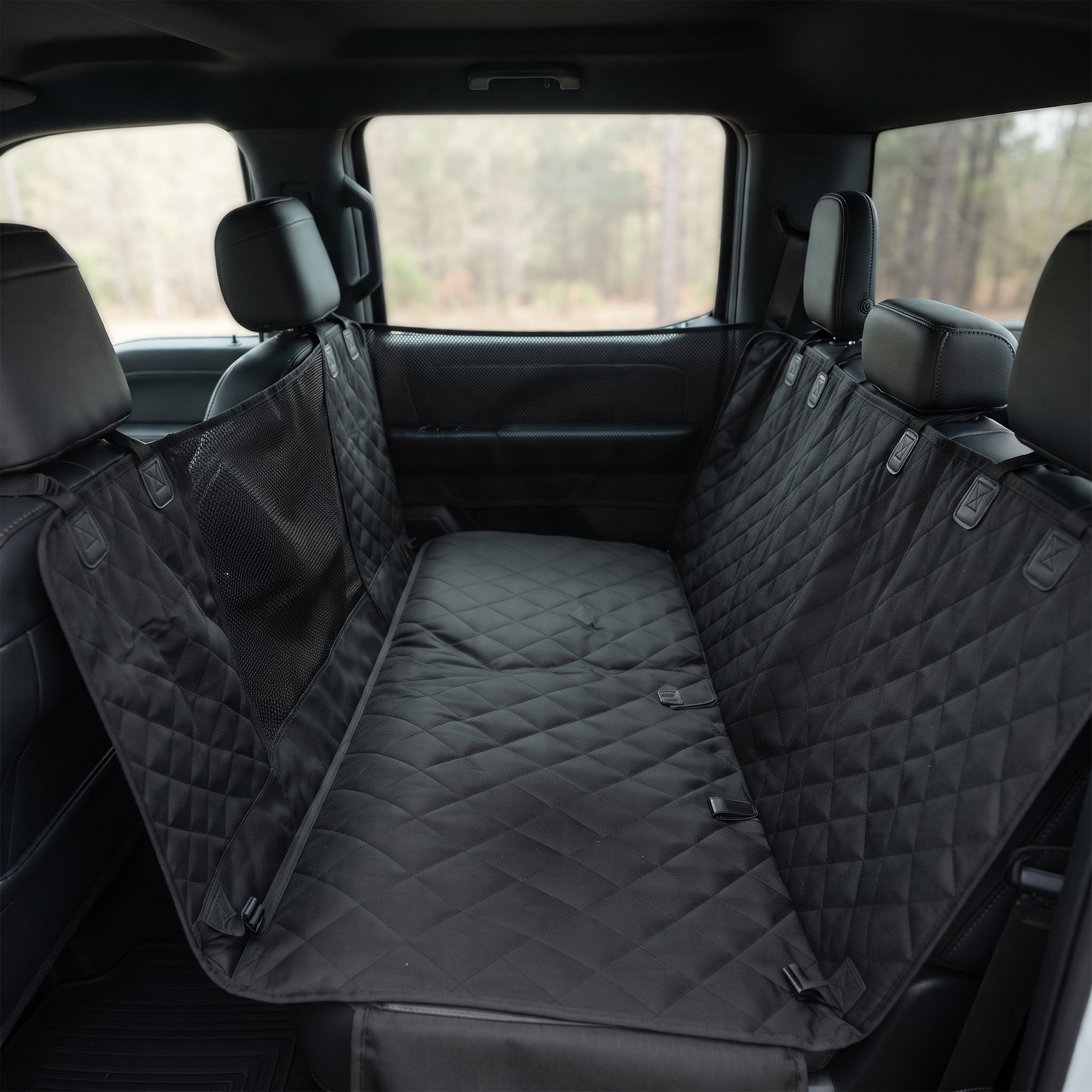 Fetch & Fuzz Dog Car Seat Cover fitted across a truck back seat with the side flaps up