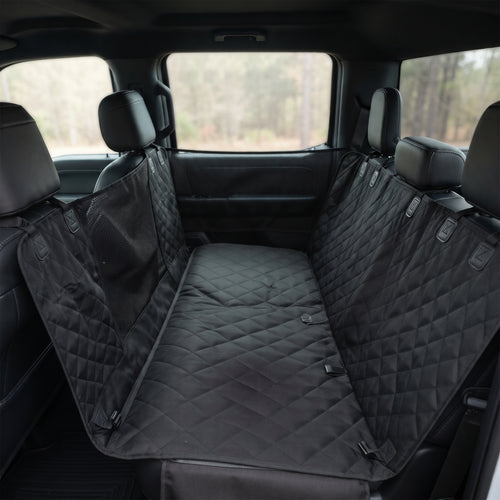 Fetch & Fuzz Dog Car Seat Cover fitted across a truck back seat with the side flaps up